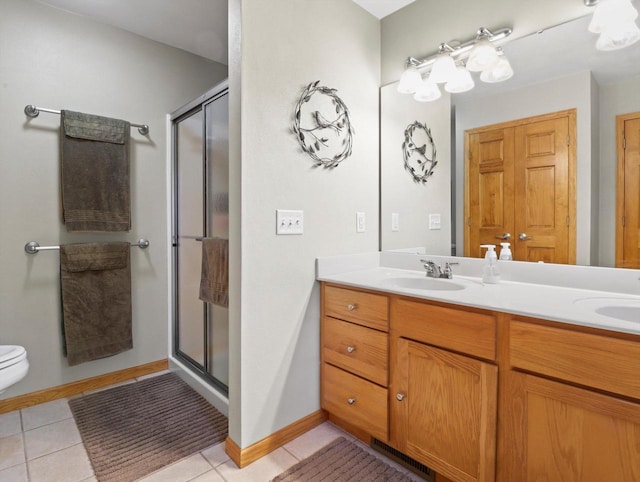 5605 N Mcnichols Dr, Milton, WI 53563 - bathroom featuring double vanity, a stall shower, toilet, and tile patterned floors