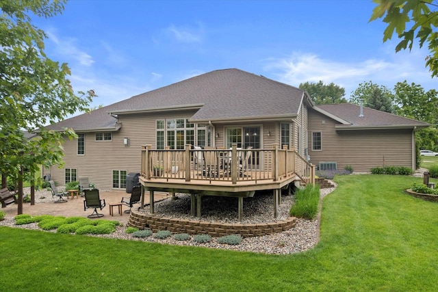 5605 N Mcnichols Dr, Milton, WI 53563 - rear view of house featuring a patio area, a deck, a lawn, and a shingled roof