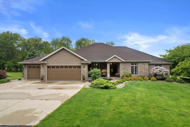 5605 N Mcnichols Dr, Milton, WI 53563 - view of front of property with a garage, concrete driveway, a front lawn, and brick siding