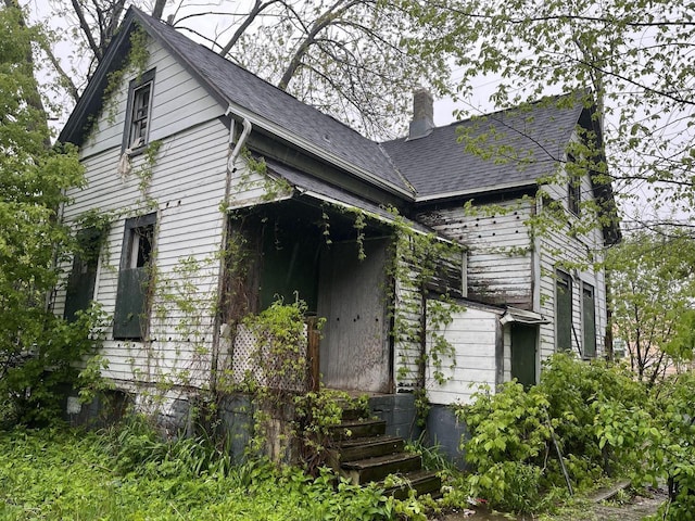 503 W Chambers St, Milwaukee, WI 53212 - view of property exterior with a chimney and a shingled roof