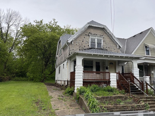 503 W Chambers St, Milwaukee, WI 53212 - view of front facade featuring covered porch, a shingled roof, and a front yard