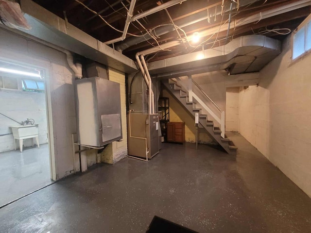 324 N Pine St, Reedsburg, WI 53959 - basement featuring stairway, heating unit, and a sink