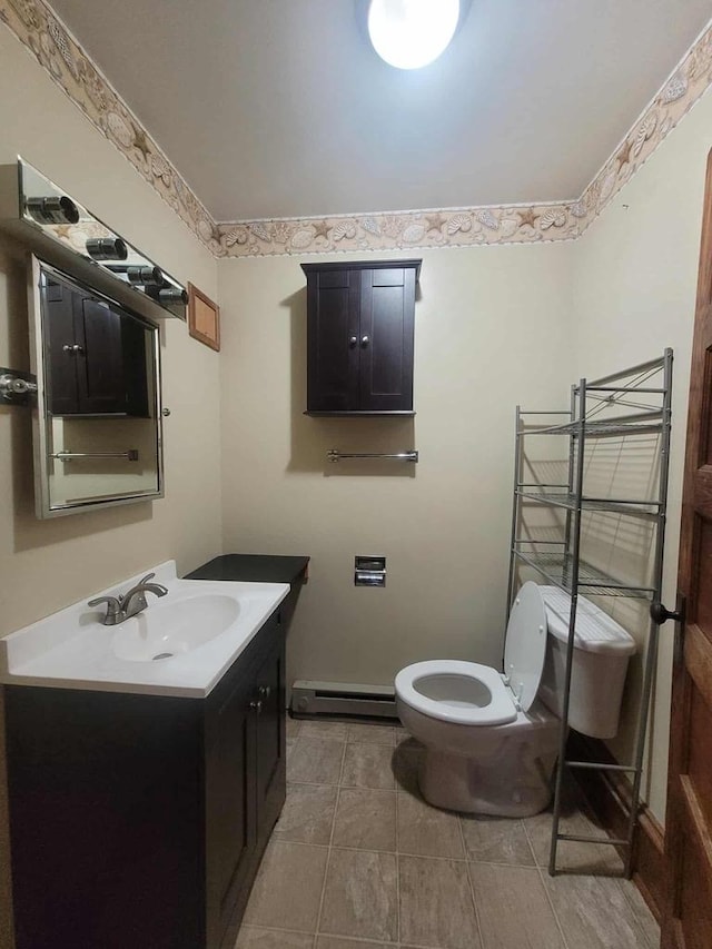 324 N Pine St, Reedsburg, WI 53959 - bathroom featuring baseboard heating, toilet, and vanity