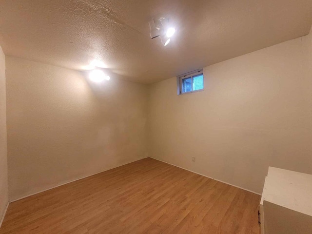 324 N Pine St, Reedsburg, WI 53959 - below grade area with light wood-style floors and a textured ceiling