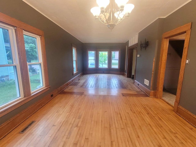 324 N Pine St, Reedsburg, WI 53959 - spare room with a chandelier, light wood-type flooring, baseboards, and ornamental molding