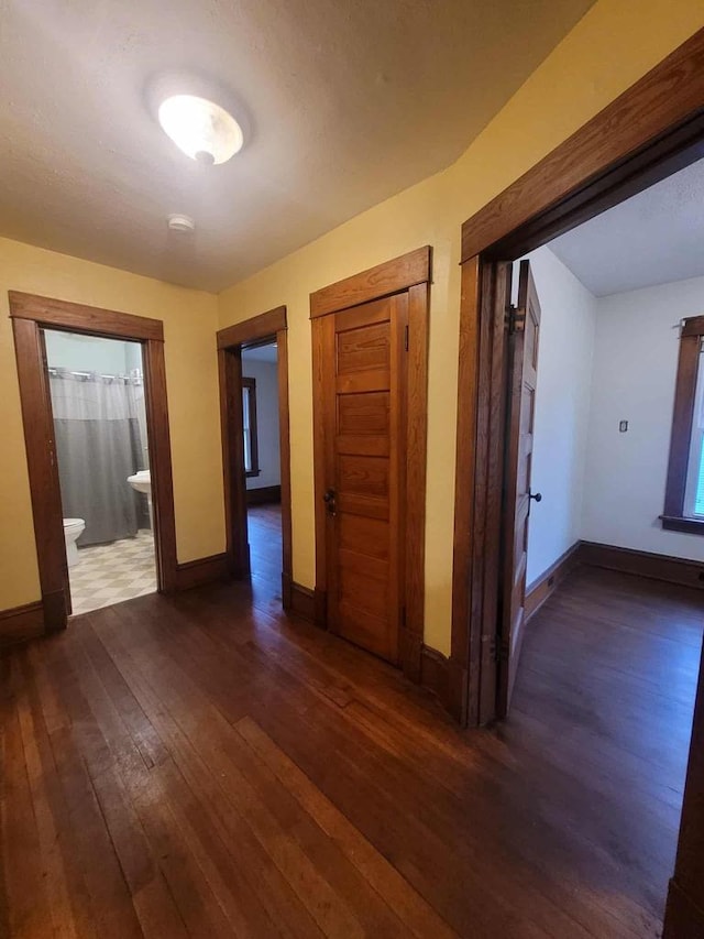 324 N Pine St, Reedsburg, WI 53959 - corridor featuring dark wood-style flooring and baseboards