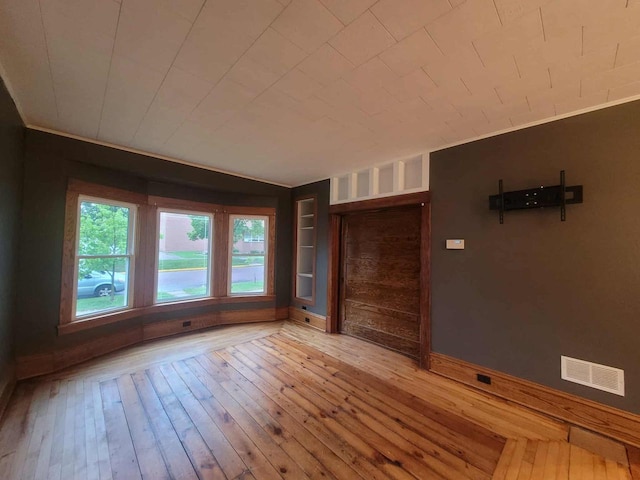 324 N Pine St, Reedsburg, WI 53959 - spare room featuring hardwood / wood-style floors, baseboards, and built in shelves