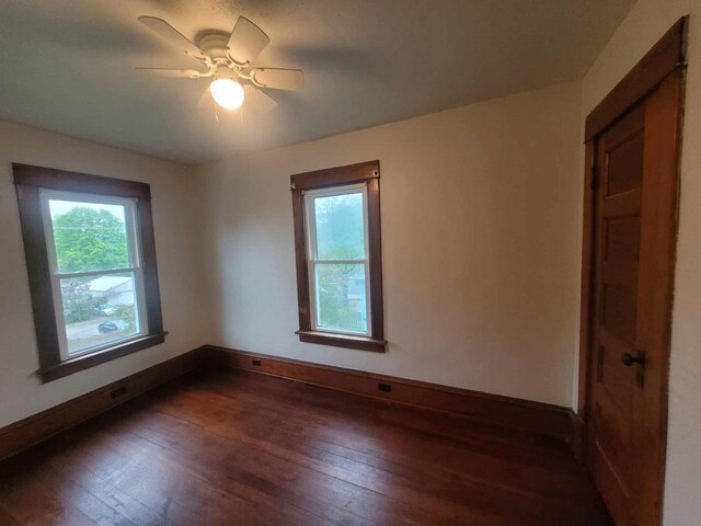 324 N Pine St, Reedsburg, WI 53959 - unfurnished room featuring healthy amount of natural light, dark wood finished floors, and baseboards