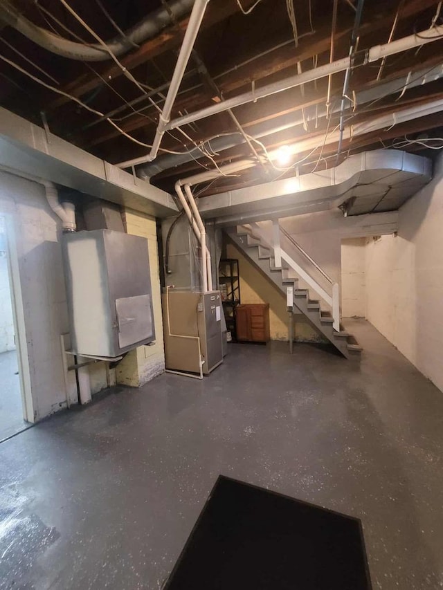 324 N Pine St, Reedsburg, WI 53959 - unfinished basement featuring stairs and heating unit
