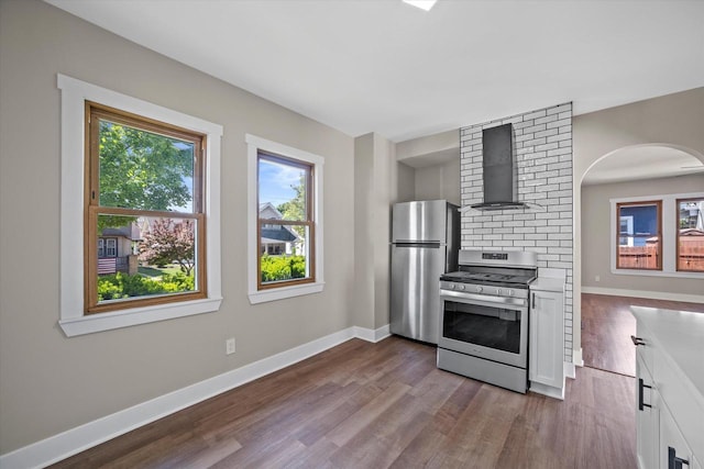 1114 E Manitoba St, Milwaukee, WI 53207 - kitchen featuring wall chimney range hood, appliances with stainless steel finishes, dark wood-style flooring, and baseboards