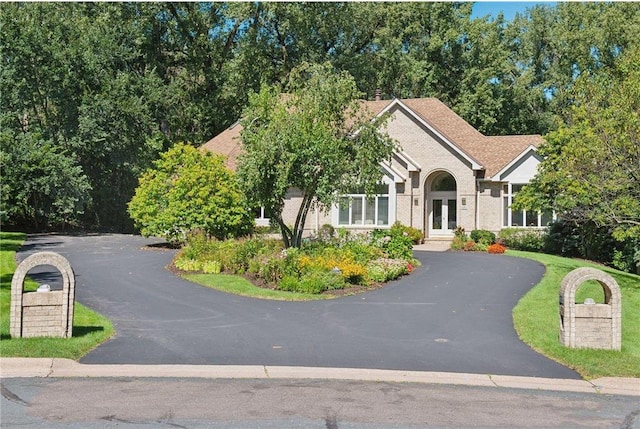 689 Brookside Ln, Mendota Heights, MN 55118 - obstructed view of property with french doors and asphalt driveway