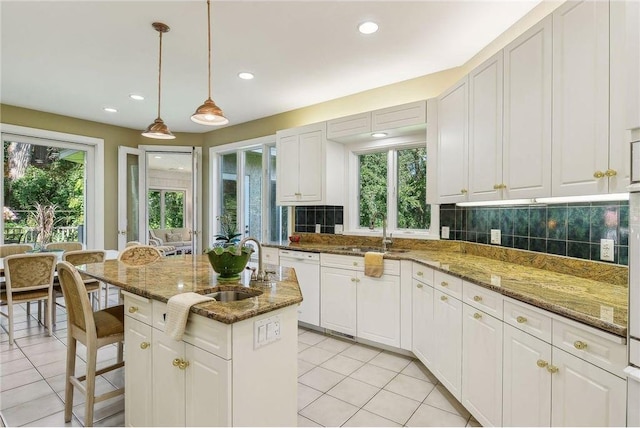 689 Brookside Ln, Mendota Heights, MN 55118 - kitchen featuring a sink, light tile patterned floors, white dishwasher, decorative backsplash, and white cabinetry
