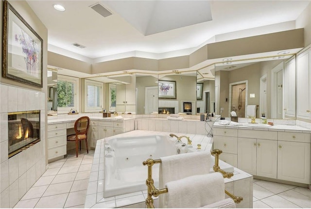 689 Brookside Ln, Mendota Heights, MN 55118 - bathroom featuring a fireplace, tile patterned flooring, vanity, a whirlpool tub, and recessed lighting