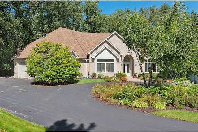 689 Brookside Ln, Mendota Heights, MN 55118 - view of front of home featuring driveway, brick siding, and an attached garage