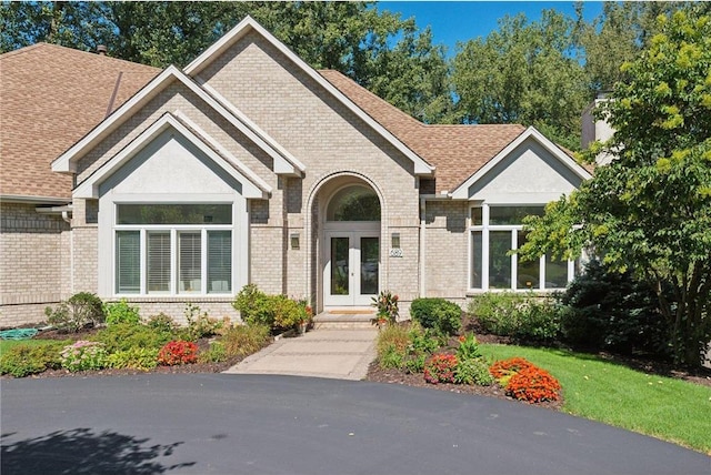 689 Brookside Ln, Mendota Heights, MN 55118 - view of front of property featuring french doors, brick siding, and roof with shingles