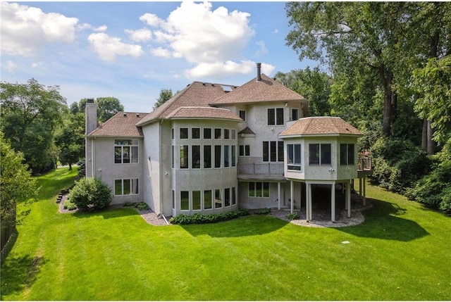 689 Brookside Ln, Mendota Heights, MN 55118 - back of house featuring stucco siding, a yard, a deck, and a chimney
