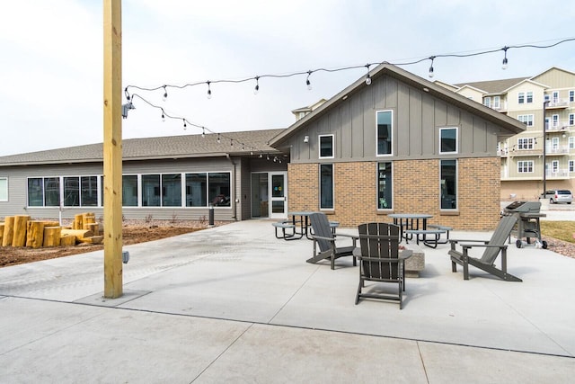 1325 Hagar St, La Crosse, WI 54603 - back of property featuring board and batten siding, brick siding, and a patio