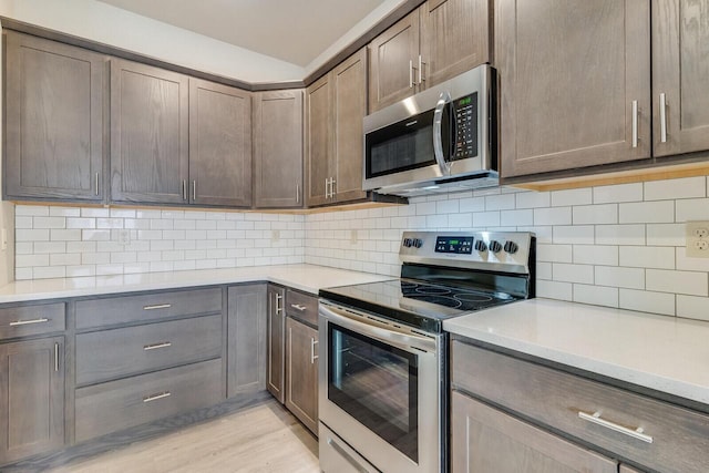 1325 Hagar St, La Crosse, WI 54603 - kitchen with appliances with stainless steel finishes, light countertops, light wood-style floors, and backsplash