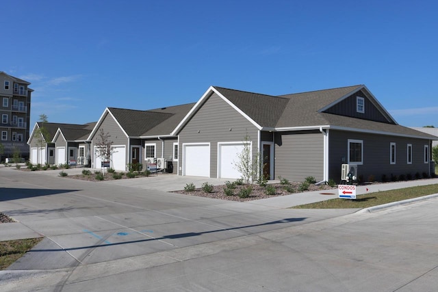 1325 Hagar St, La Crosse, WI 54603 - view of front of property with concrete driveway, a garage, and board and batten siding