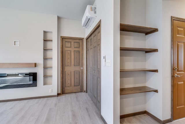 1325 Hagar St, La Crosse, WI 54603 - entryway featuring a wall mounted air conditioner, light wood finished floors, and baseboards