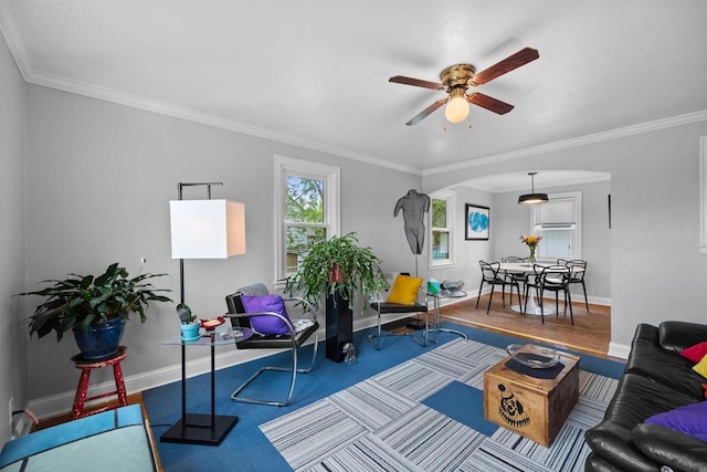 841 4th St S, Wisconsin Rapids, WI 54494 - living room with arched walkways, a ceiling fan, baseboards, ornamental molding, and wood finished floors