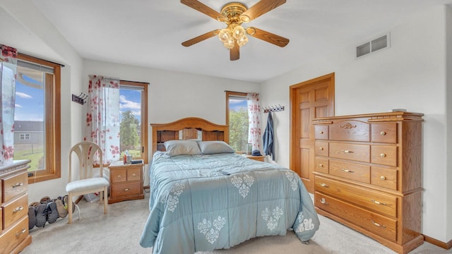323 Autumn Ln, Campbellsport, WI 53010 - carpeted bedroom featuring multiple windows and ceiling fan