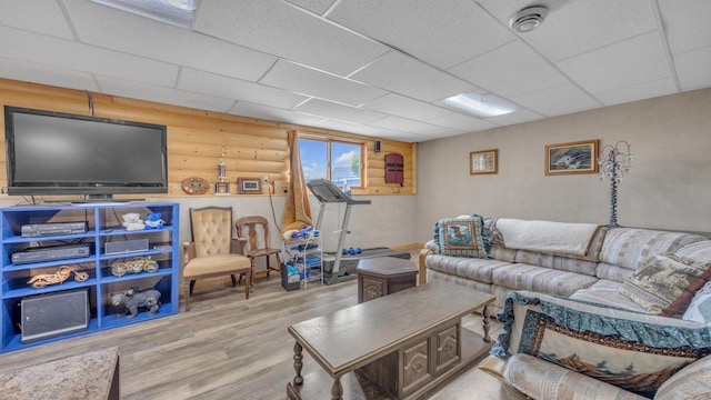 323 Autumn Ln, Campbellsport, WI 53010 - living area featuring wood finished floors, a paneled ceiling, and rustic walls