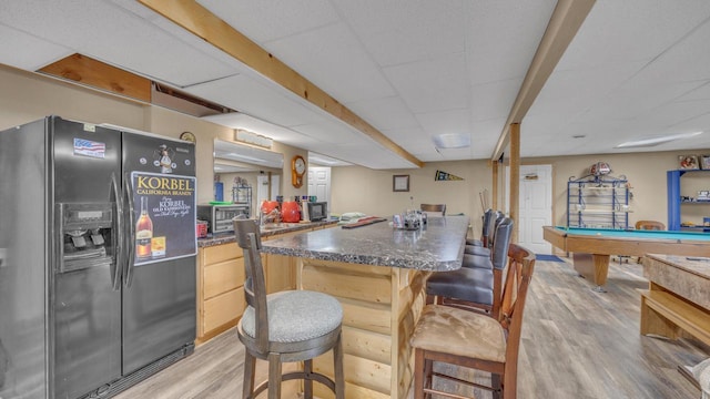323 Autumn Ln, Campbellsport, WI 53010 - kitchen with refrigerator with ice dispenser, light wood-style floors, a breakfast bar, a paneled ceiling, and billiards
