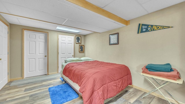 323 Autumn Ln, Campbellsport, WI 53010 - bedroom with wood finished floors, a paneled ceiling, and baseboards
