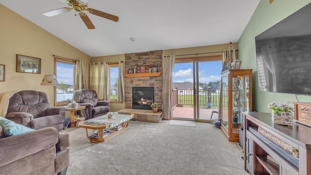 323 Autumn Ln, Campbellsport, WI 53010 - carpeted living area with lofted ceiling, a stone fireplace, and a ceiling fan