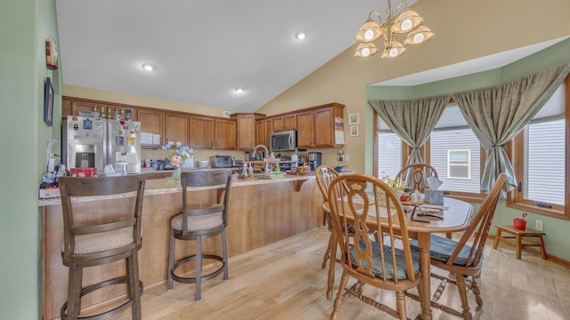 323 Autumn Ln, Campbellsport, WI 53010 - dining room featuring vaulted ceiling, a chandelier, recessed lighting, and light wood-style floors