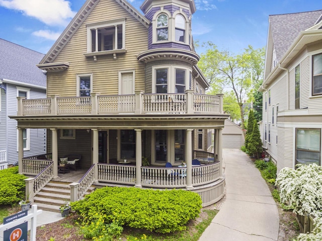 2710 N Hackett Ave, Milwaukee, WI 53211 - victorian house with covered porch, an outdoor structure, and a garage