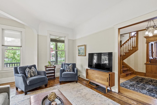 2710 N Hackett Ave, Milwaukee, WI 53211 - living area with stairway, wood finished floors, and a chandelier