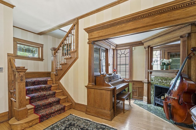 2710 N Hackett Ave, Milwaukee, WI 53211 - foyer entrance featuring hardwood / wood-style flooring, stairway, plenty of natural light, crown molding, and a tile fireplace