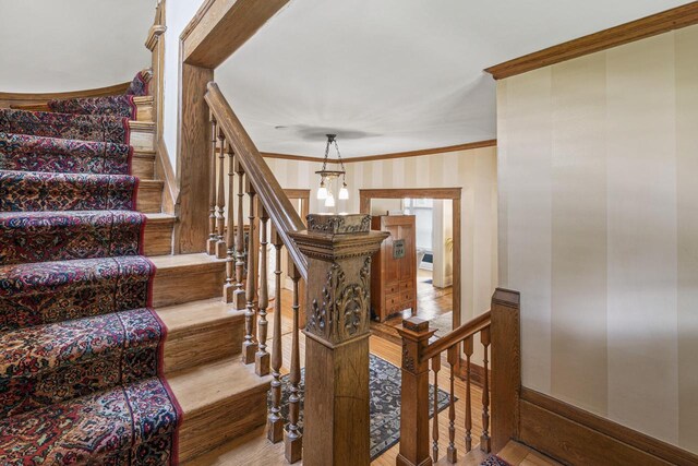 2710 N Hackett Ave, Milwaukee, WI 53211 - stairs with ornamental molding, wood finished floors, and wallpapered walls
