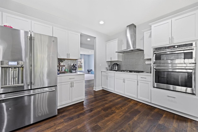 19750 Heron Pass, Brookfield, WI 53045 - kitchen featuring stainless steel appliances, wall chimney exhaust hood, decorative backsplash, dark wood finished floors, and recessed lighting