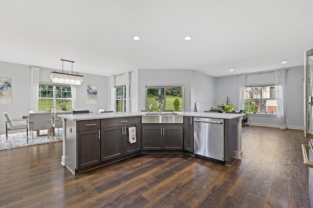 19750 Heron Pass, Brookfield, WI 53045 - kitchen with stainless steel dishwasher, a sink, light countertops, dark wood-style floors, and dark brown cabinetry