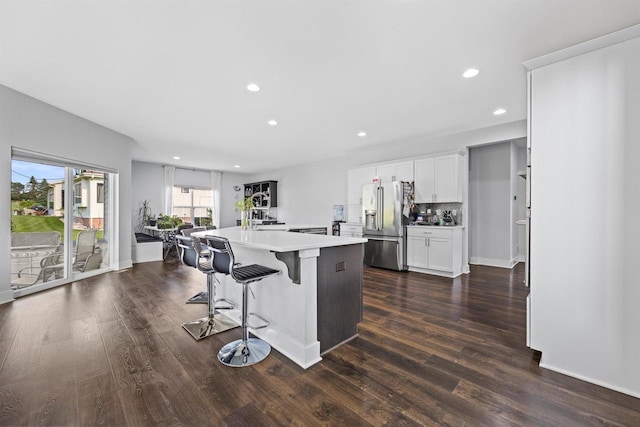 19750 Heron Pass, Brookfield, WI 53045 - kitchen with high end fridge, light countertops, dark wood finished floors, recessed lighting, and an island with sink