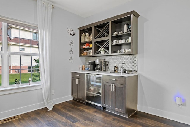 19750 Heron Pass, Brookfield, WI 53045 - indoor dry bar featuring beverage cooler, decorative backsplash, baseboards, and dark wood-style flooring