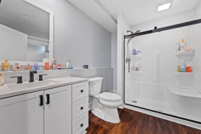 19750 Heron Pass, Brookfield, WI 53045 - bathroom with wood finished floors, a stall shower, toilet, vanity, and a textured wall