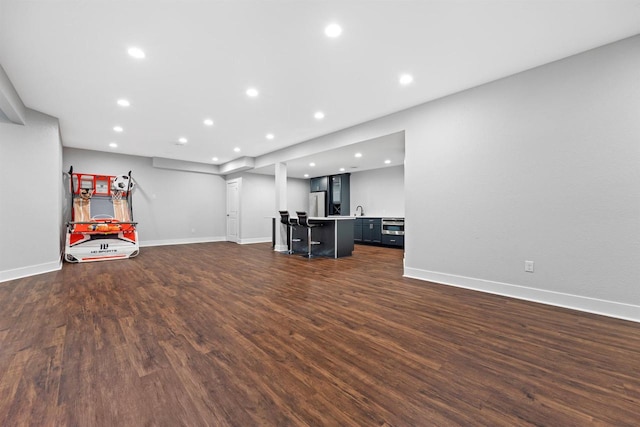 19750 Heron Pass, Brookfield, WI 53045 - unfurnished living room featuring recessed lighting, dark wood-style floors, baseboards, and bar area