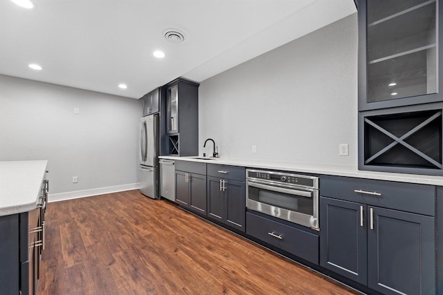 19750 Heron Pass, Brookfield, WI 53045 - kitchen with appliances with stainless steel finishes, a sink, light countertops, dark wood-style floors, and baseboards