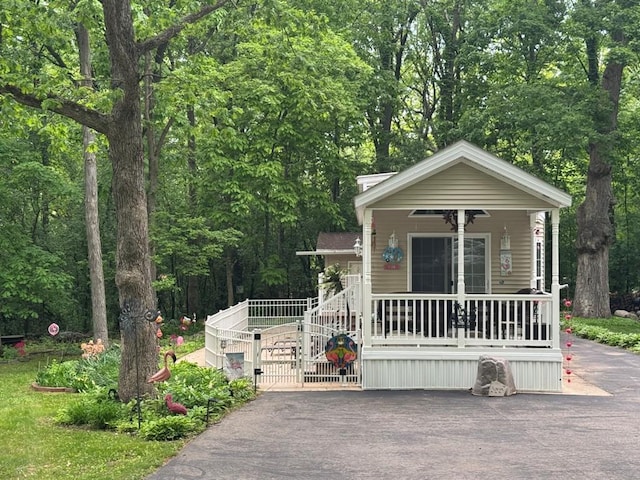 269 Oak Ln, Edgerton, WI 53534 - view of front of home featuring covered porch, a gate, and asphalt driveway