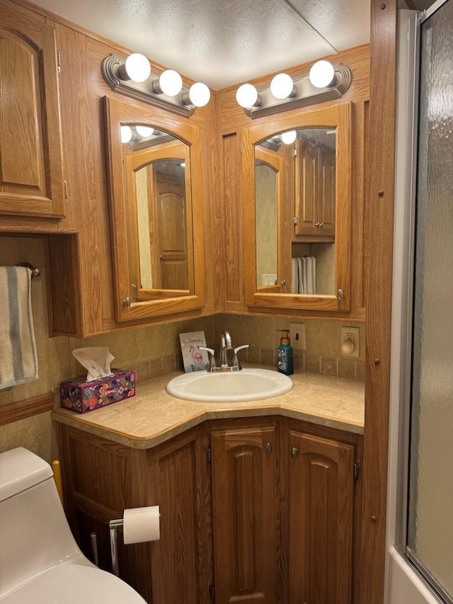 269 Oak Ln, Edgerton, WI 53534 - full bath featuring toilet, vanity, and a shower with door