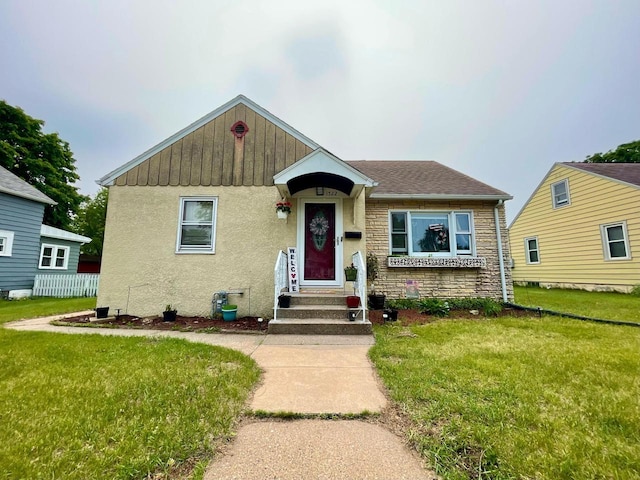 1522 Barlow St, La Crosse, WI 54601 - bungalow featuring a front lawn, stone siding, and stucco siding