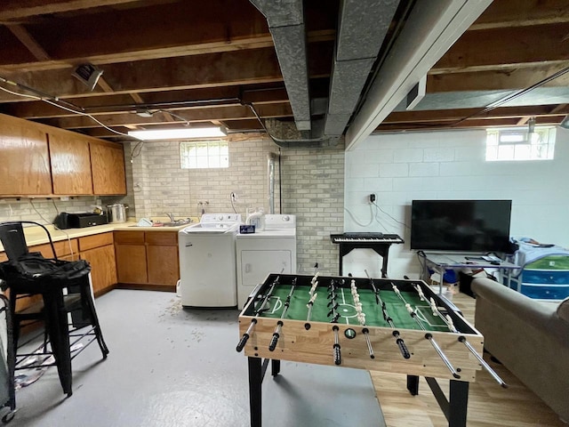 1522 Barlow St, La Crosse, WI 54601 - playroom featuring washer and dryer, a sink, and concrete flooring