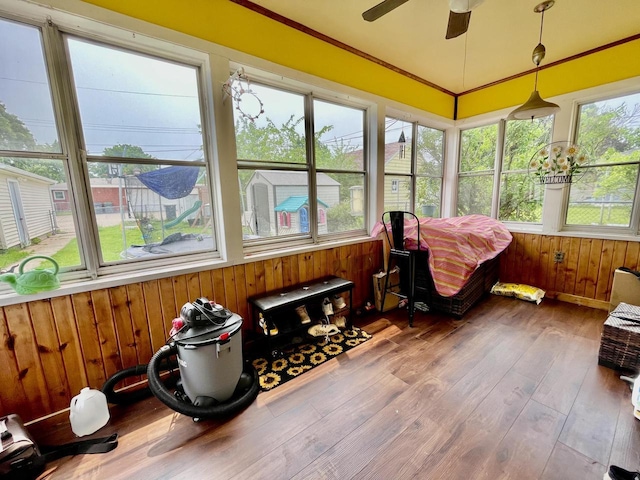 1522 Barlow St, La Crosse, WI 54601 - sunroom with a ceiling fan, wooden walls, wood finished floors, and crown molding