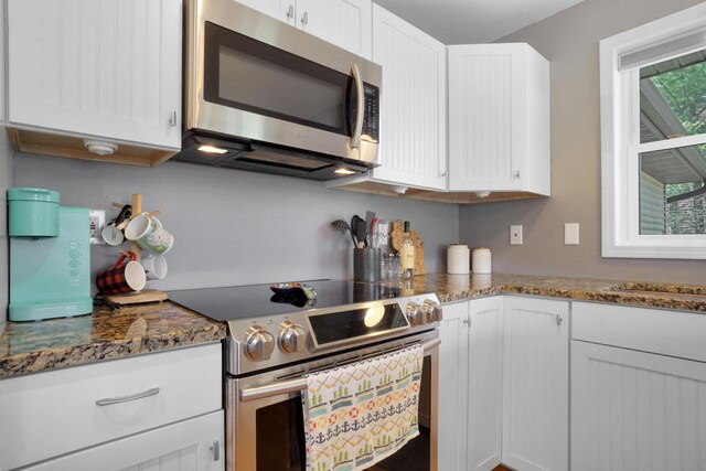 1014 Long Bow Ct, Nekoosa, WI 54457 - kitchen featuring stainless steel appliances, white cabinets, and dark stone countertops