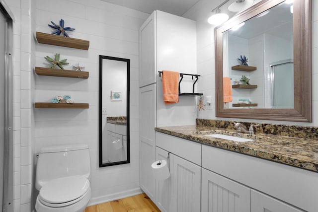 1014 Long Bow Ct, Nekoosa, WI 54457 - full bath with vanity, wood finished floors, toilet, and a shower with shower door