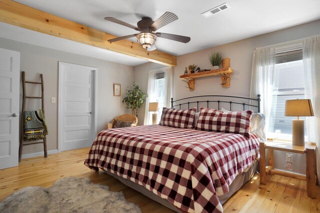 1014 Long Bow Ct, Nekoosa, WI 54457 - bedroom with light wood-type flooring, beamed ceiling, a ceiling fan, and baseboards